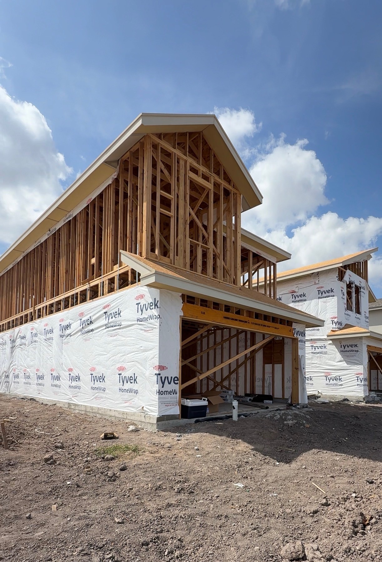 Residential wood framing and house wrap on an active construction site